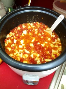 Diced chicken cooking in diced tomatoes and garlic (In Rice Cooker)